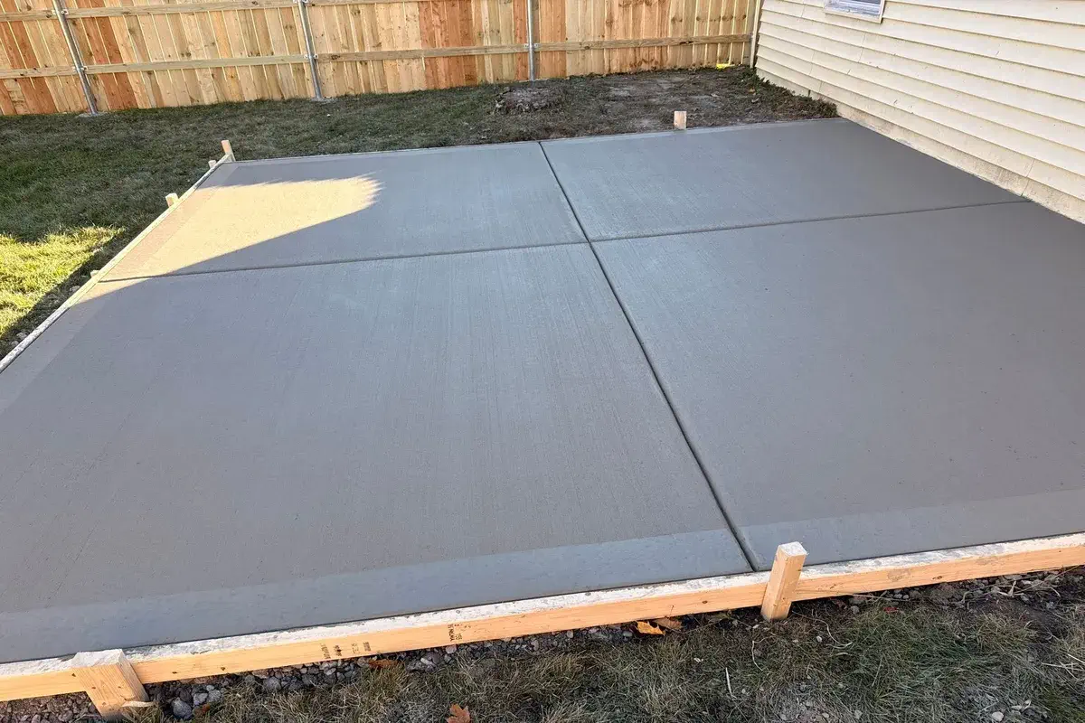 Freshly poured concrete slab still set in its wood forms