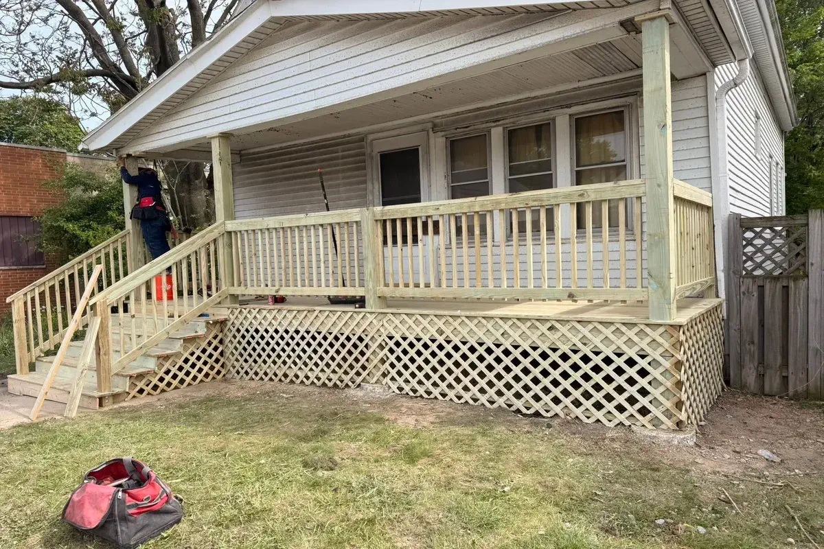 Covered front porch with new railing and lattice skirting
